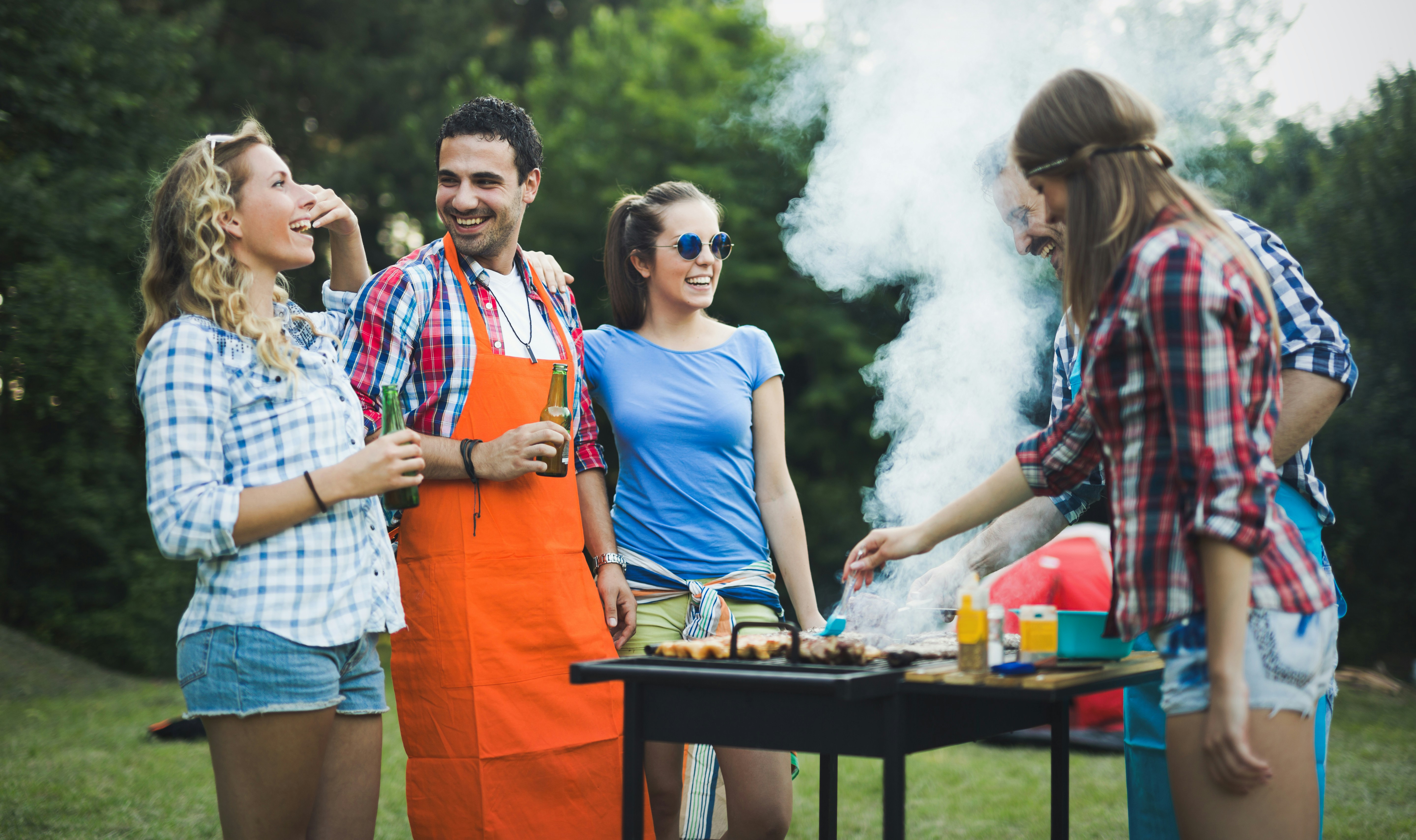 Neighbors laughing together at a casual outdoor gathering